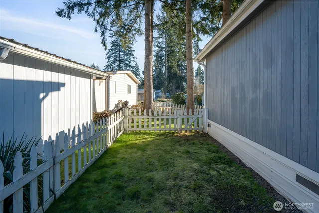 a view of a yard with wooden fence