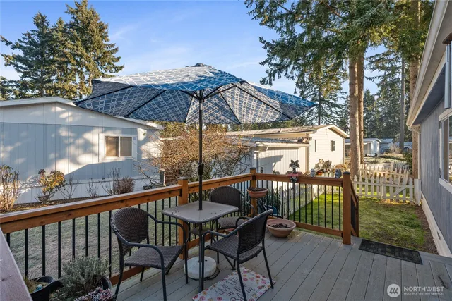 a view of a chair and table on the deck