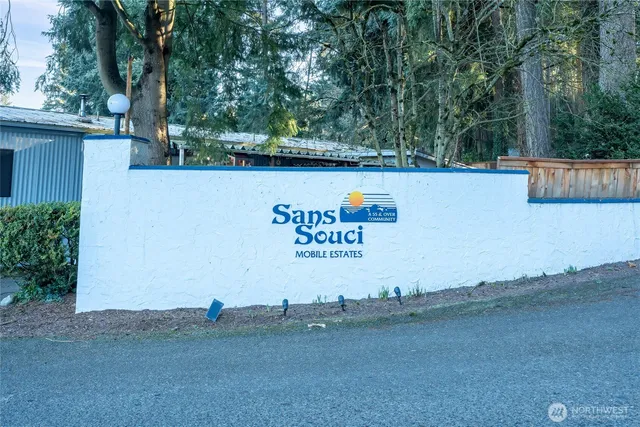 a view of a street with a barn in the background