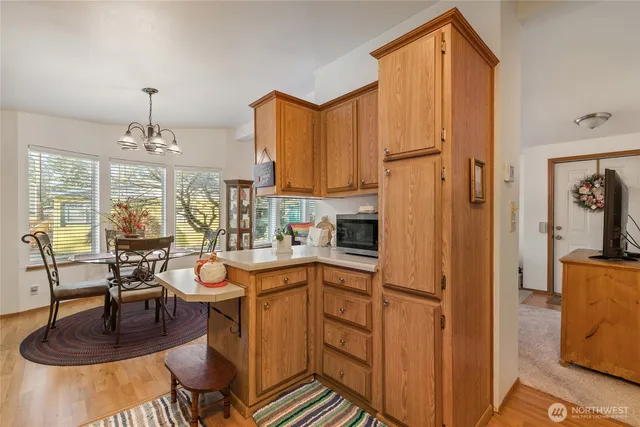 a kitchen with sink refrigerator and cabinets