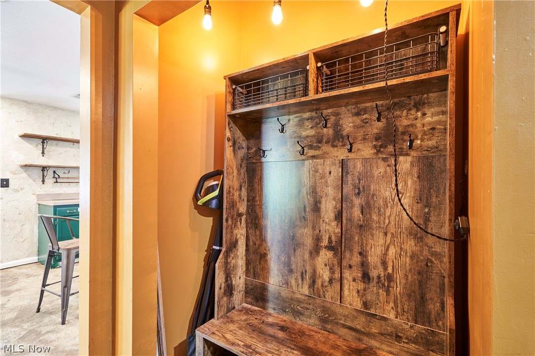 780 Bates Road Rocky River, OH 44116 - Photo 25 of 35 Custom wood-finish entryway organizer featuring integrated seating, coat hooks, and upper storage baskets