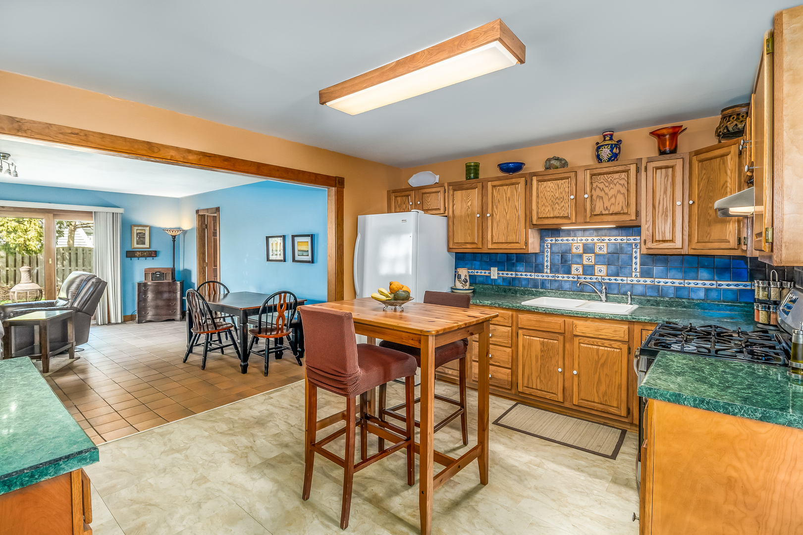 518 Amherst Avenue Romeoville, IL 60446 - Photo 5 of 23 a kitchen with stainless steel appliances granite countertop a table chairs and a refrigerator