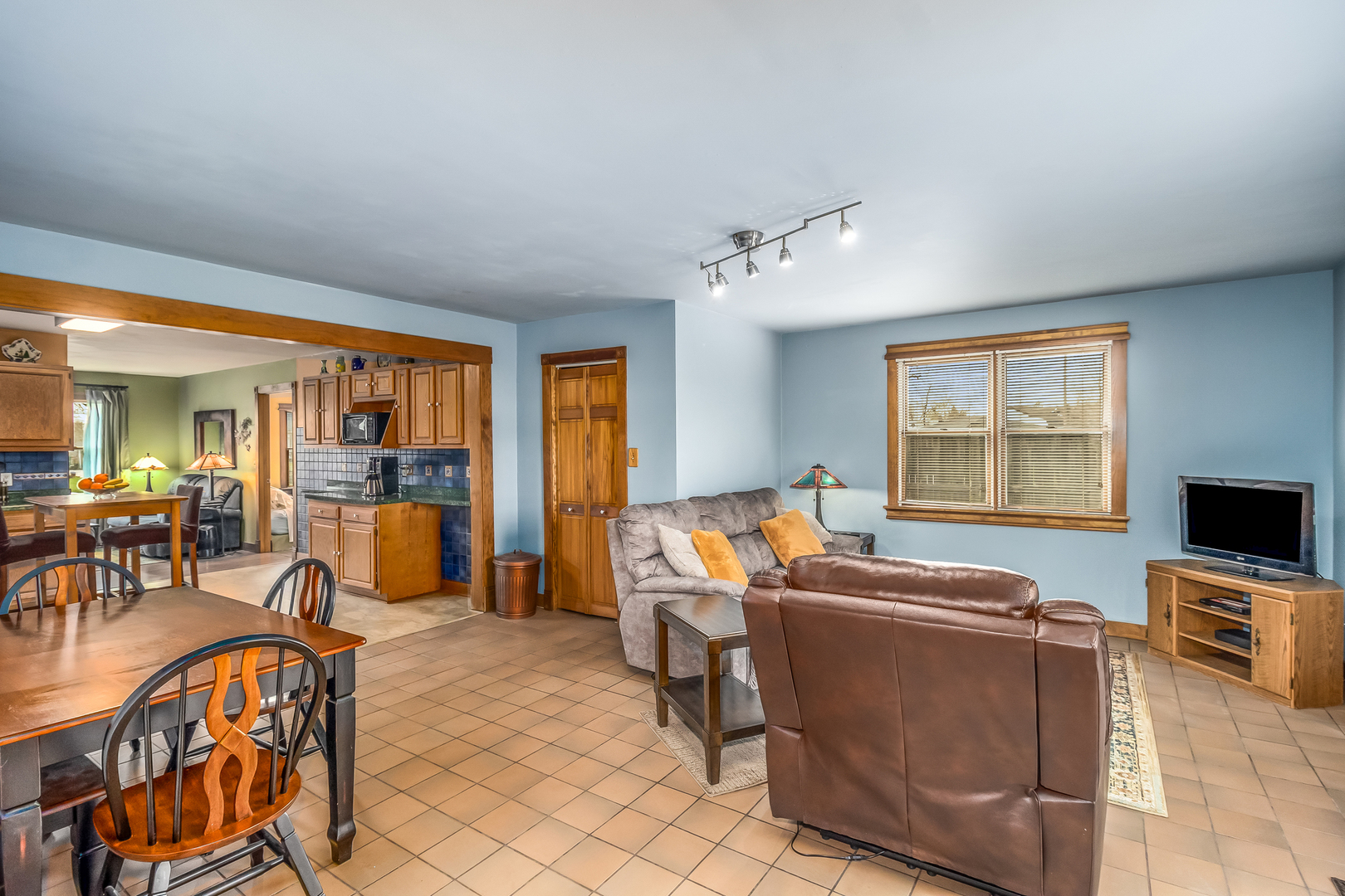 518 Amherst Avenue Romeoville, IL 60446 - Photo 8 of 23 a living room with furniture a flat screen tv and floor to ceiling window