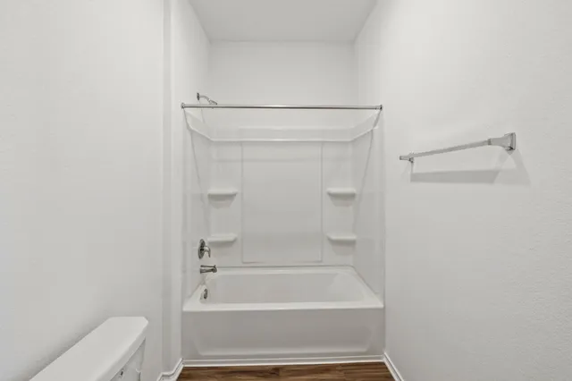 a bathroom with a bathtub and shower