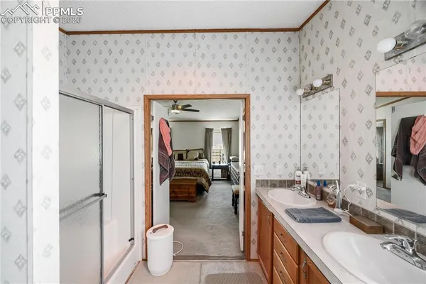 a en suite bathroom with a granite countertop sink and a mirror