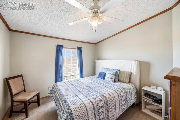 a bedroom with a bed and a chair