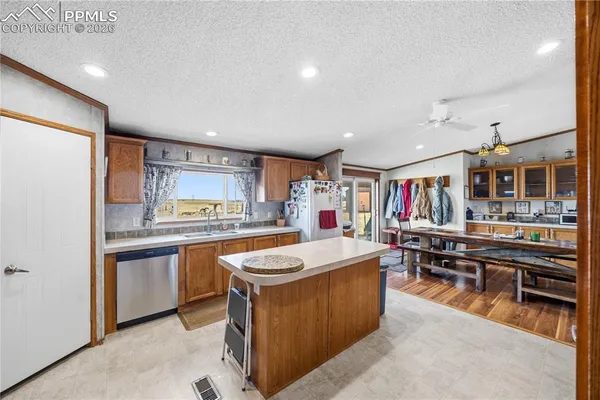 a kitchen with stainless steel appliances a sink and a refrigerator