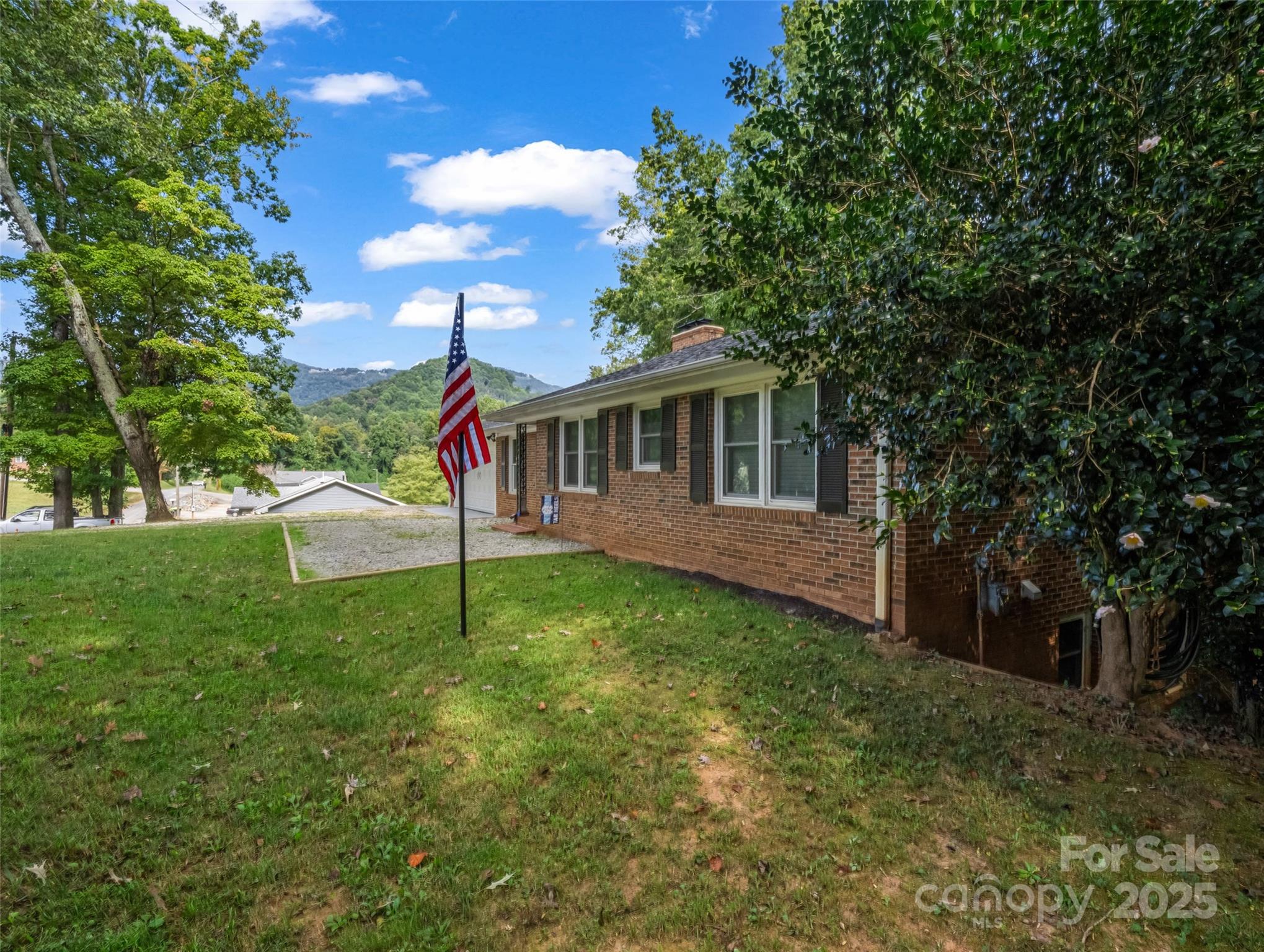 263 Blanton Street Columbus, NC 28722 - Photo 6 of 45 a view of a house with a backyard