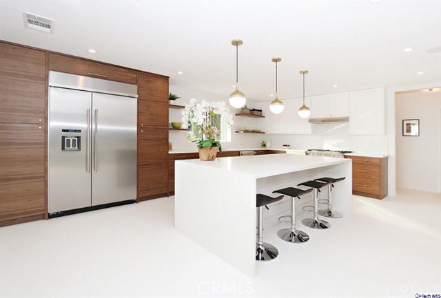 360 Kempton Road Glendale, CA 91202 - Photo 11 of 34 a kitchen with kitchen island a counter top space a sink stainless steel appliances and cabinets
