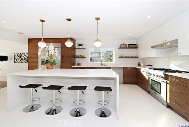 360 Kempton Road Glendale, CA 91202 - Photo 12 of 34 a kitchen with stainless steel appliances kitchen island a large island in the center and cabinets