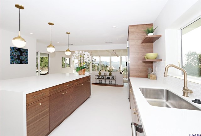 360 Kempton Road Glendale, CA 91202 - Photo 13 of 34 a large room with kitchen island a sink a counter space and a view of living room