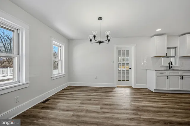 a view of a kitchen with granite countertop wooden floor and a window