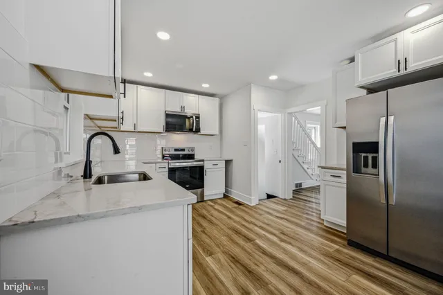 a kitchen with stainless steel appliances a refrigerator sink a stove a microwave and cabinets