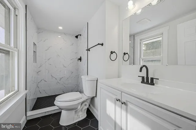 a bathroom with a toilet sink and shower