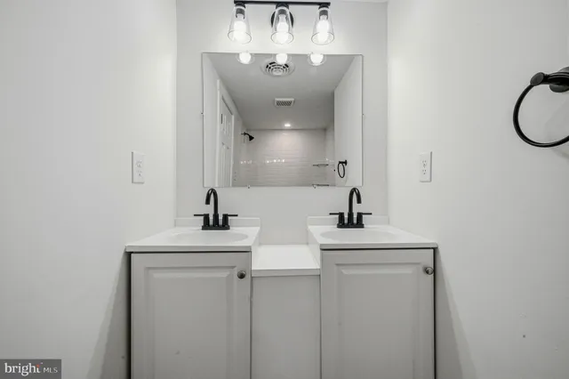a bathroom with a sink a toilet and mirror