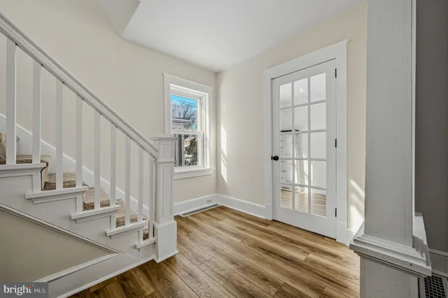 a view of entryway and hall with wooden floor