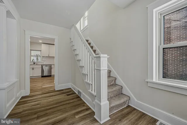 a view of a hallway view with wooden floor and staircase