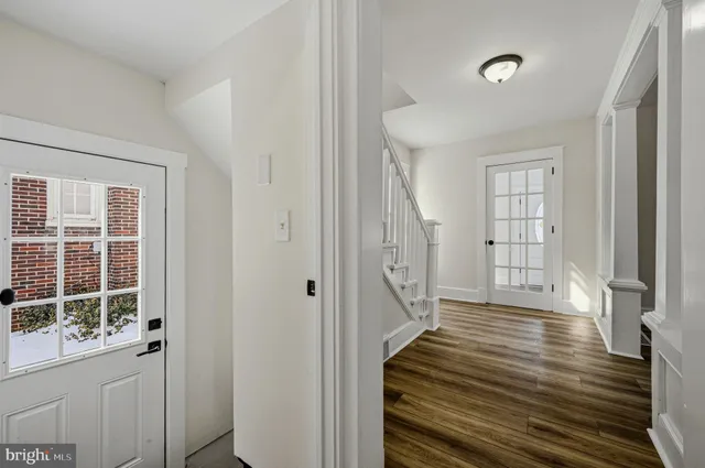 a view of a room with wooden floor and windows