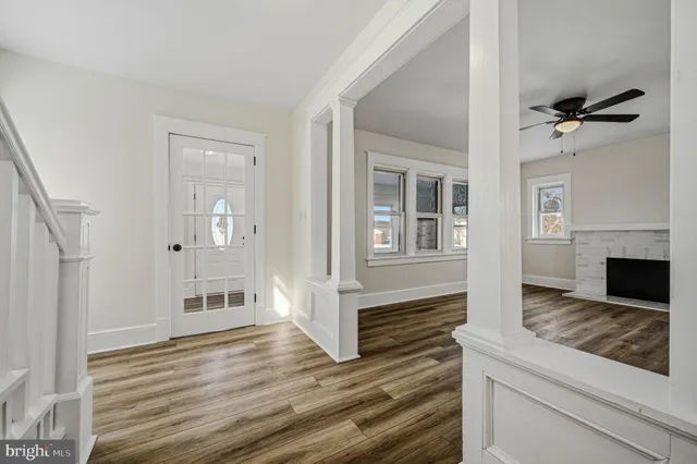 a view of a livingroom with wooden floor and a fireplace