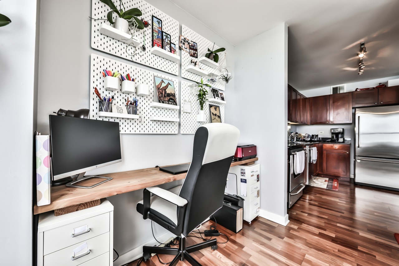 655 West Irving Park Road, Unit 3810 Chicago, IL 60613 - Photo 11 of 26 a workspace with furniture and wooden floor