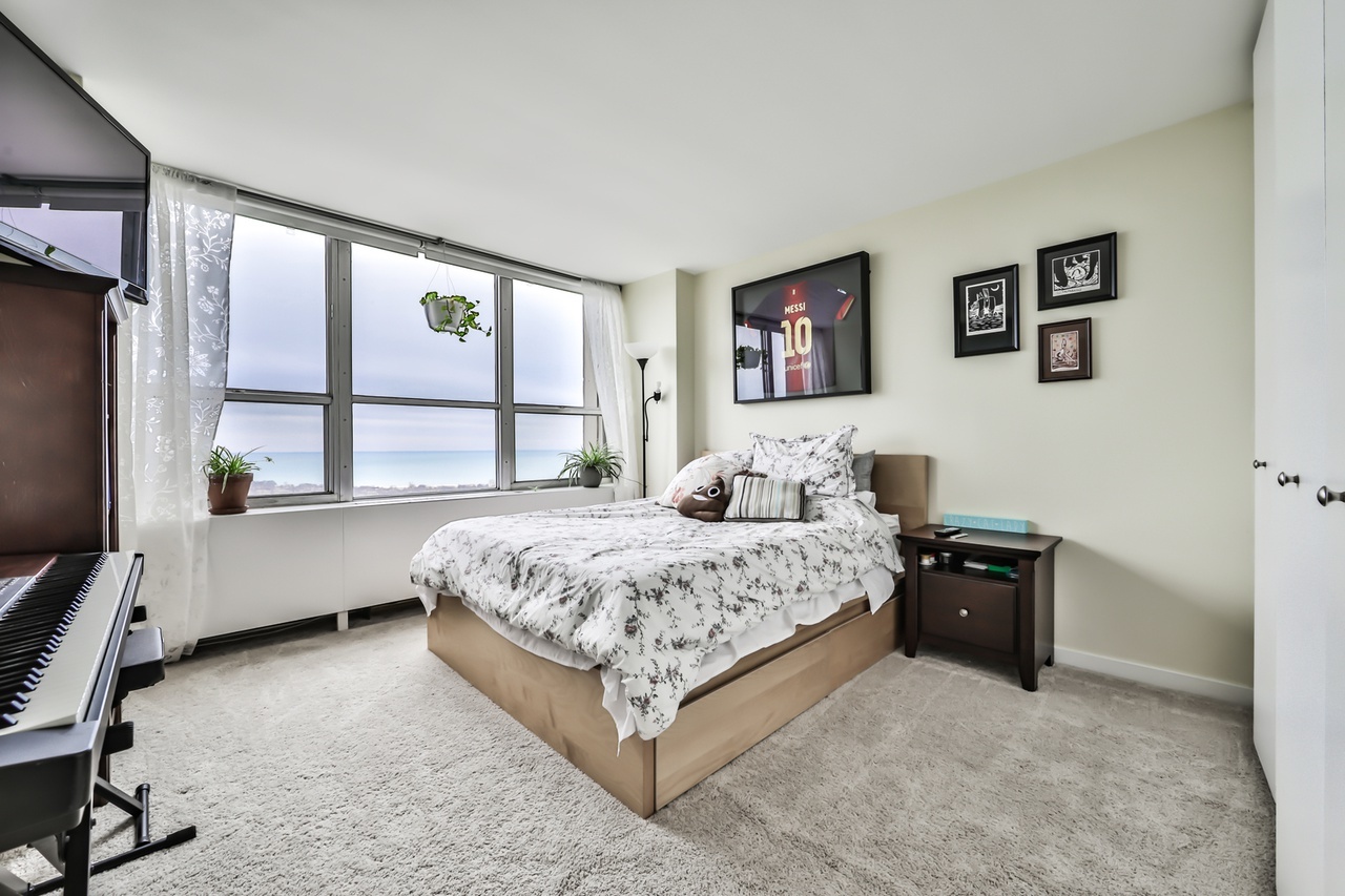 655 West Irving Park Road, Unit 3810 Chicago, IL 60613 - Photo 15 of 26 a bedroom with a bed and a window