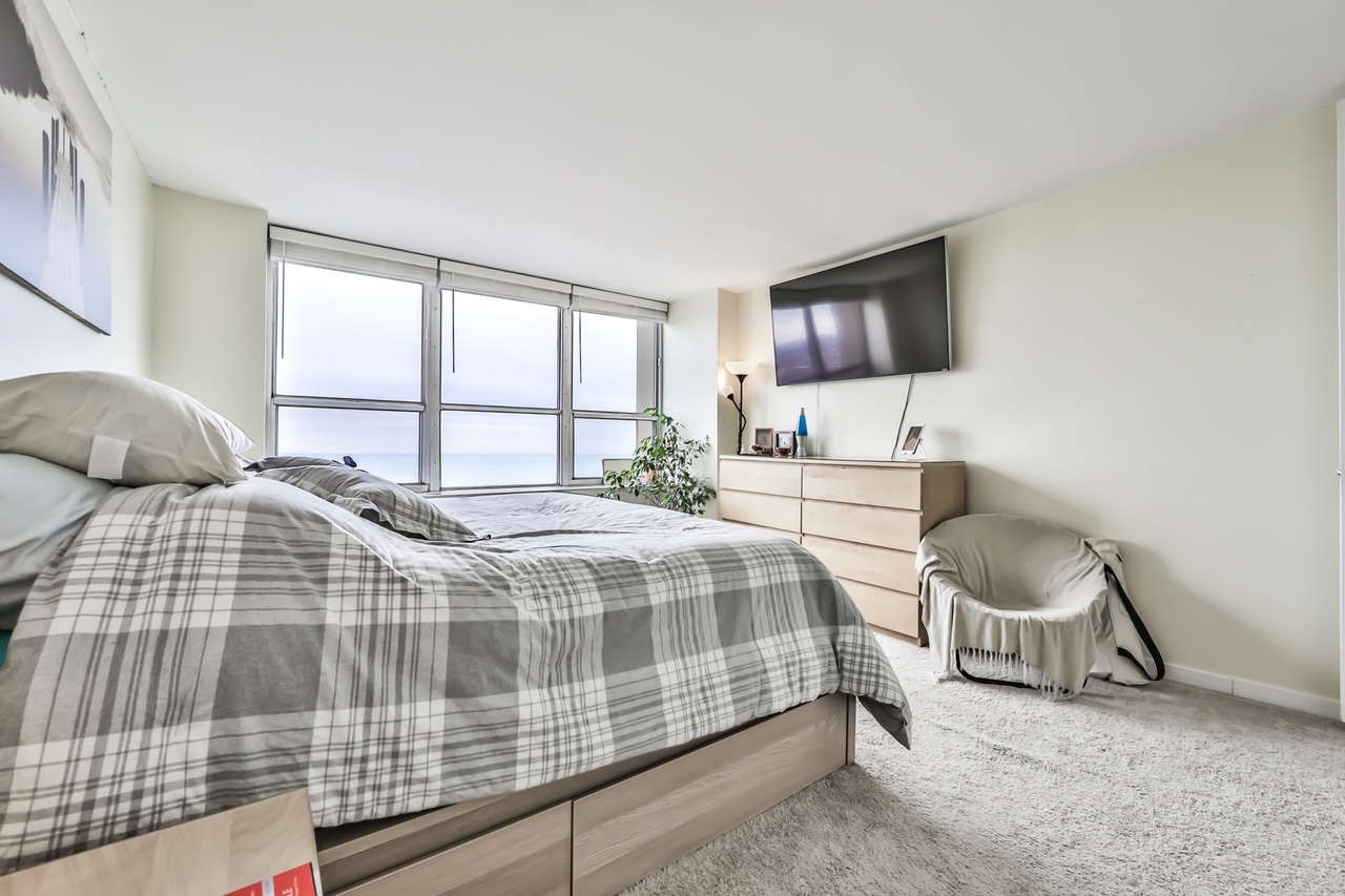 655 West Irving Park Road, Unit 3810 Chicago, IL 60613 - Photo 17 of 26 a bedroom with a bed and a window