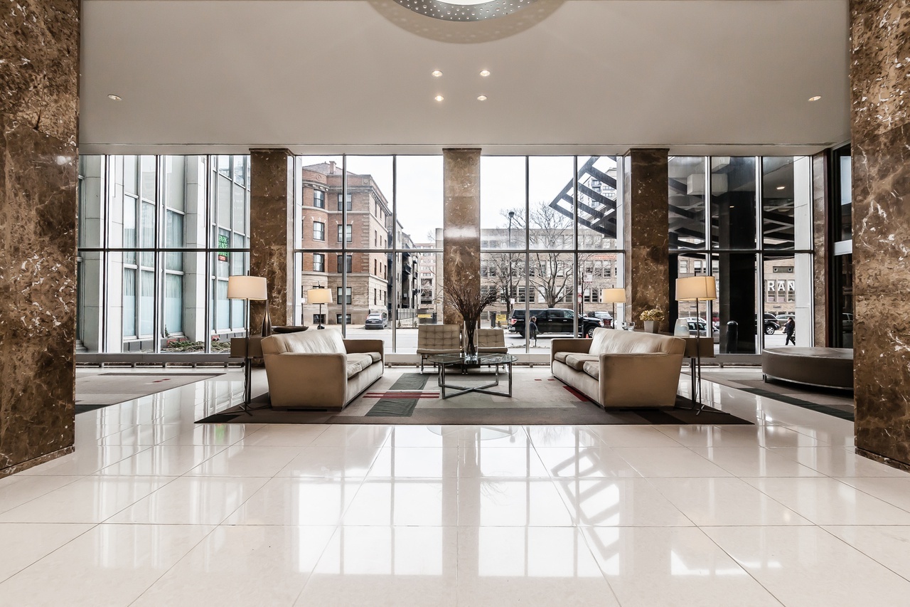655 West Irving Park Road, Unit 3810 Chicago, IL 60613 - Photo 3 of 26 a living room with furniture and large windows