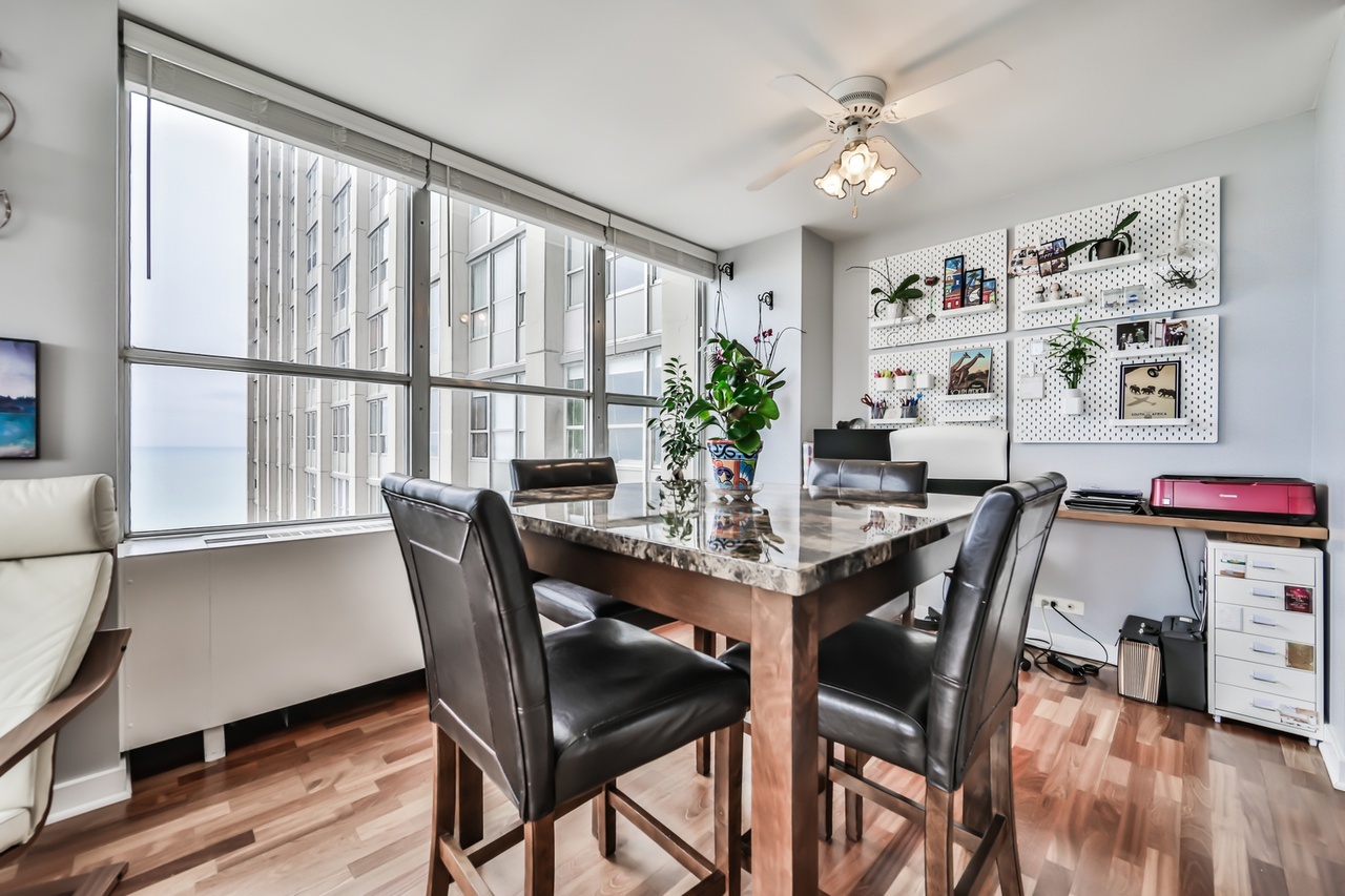 655 West Irving Park Road, Unit 3810 Chicago, IL 60613 - Photo 8 of 26 a view of a dining room with furniture window and wooden floor