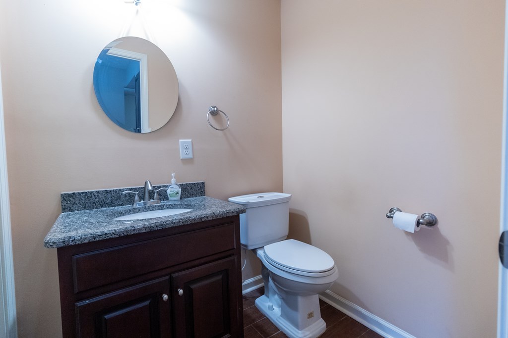 2525 Norris Road, Unit 36 Columbus, GA 31907 - Photo 14 of 28 a bathroom with a granite countertop toilet sink and mirror