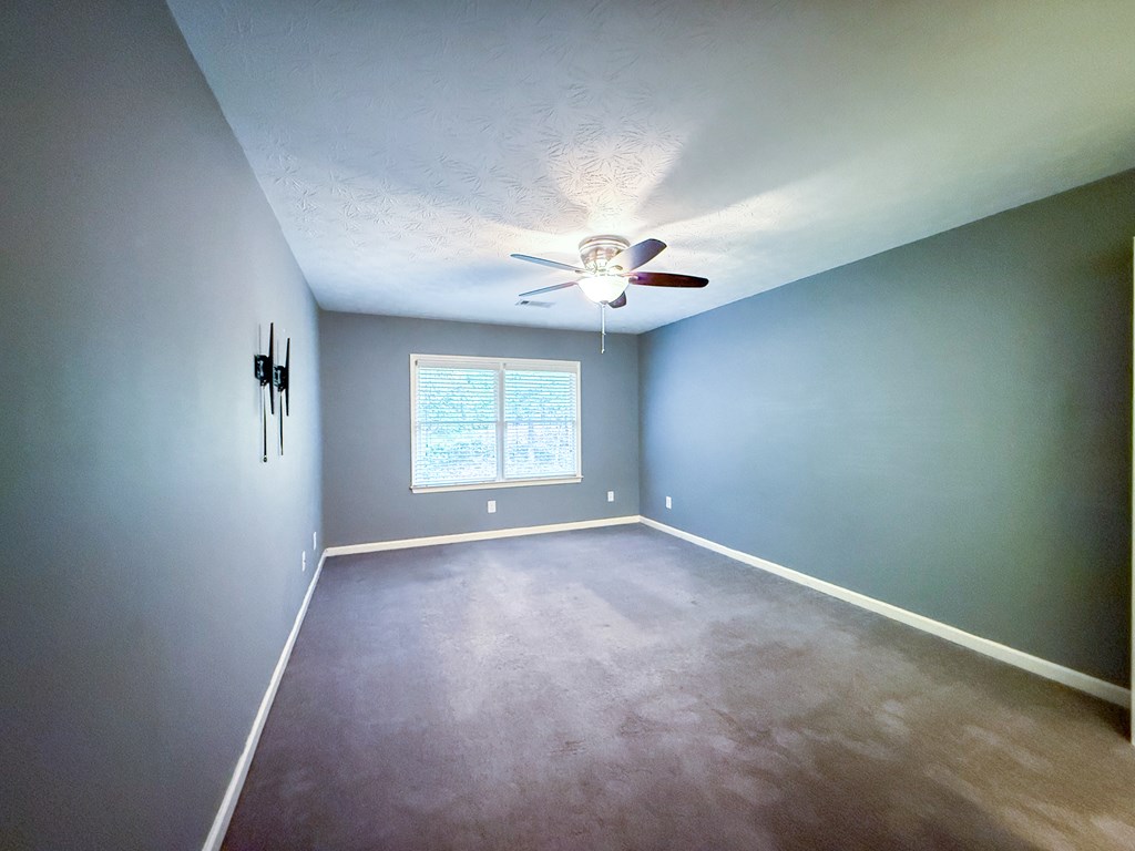 2525 Norris Road, Unit 36 Columbus, GA 31907 - Photo 18 of 28 an empty room with windows and chandelier fan