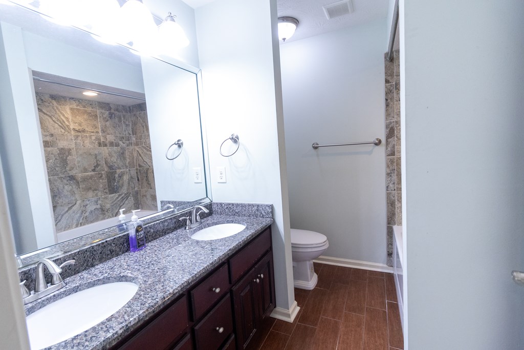 2525 Norris Road, Unit 36 Columbus, GA 31907 - Photo 20 of 28 a bathroom with a granite countertop double vanity sink a mirror and a toilet