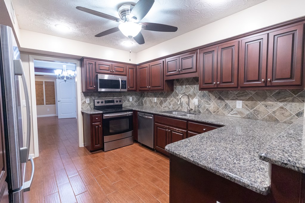 2525 Norris Road, Unit 36 Columbus, GA 31907 - Photo 4 of 28 a kitchen with stainless steel appliances granite countertop a sink dishwasher stove and refrigerator with wooden floor