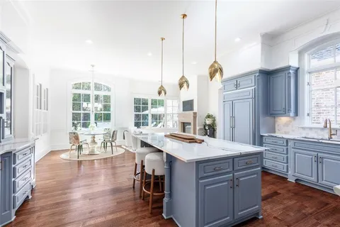 a view of kitchen island wooden floor and living room