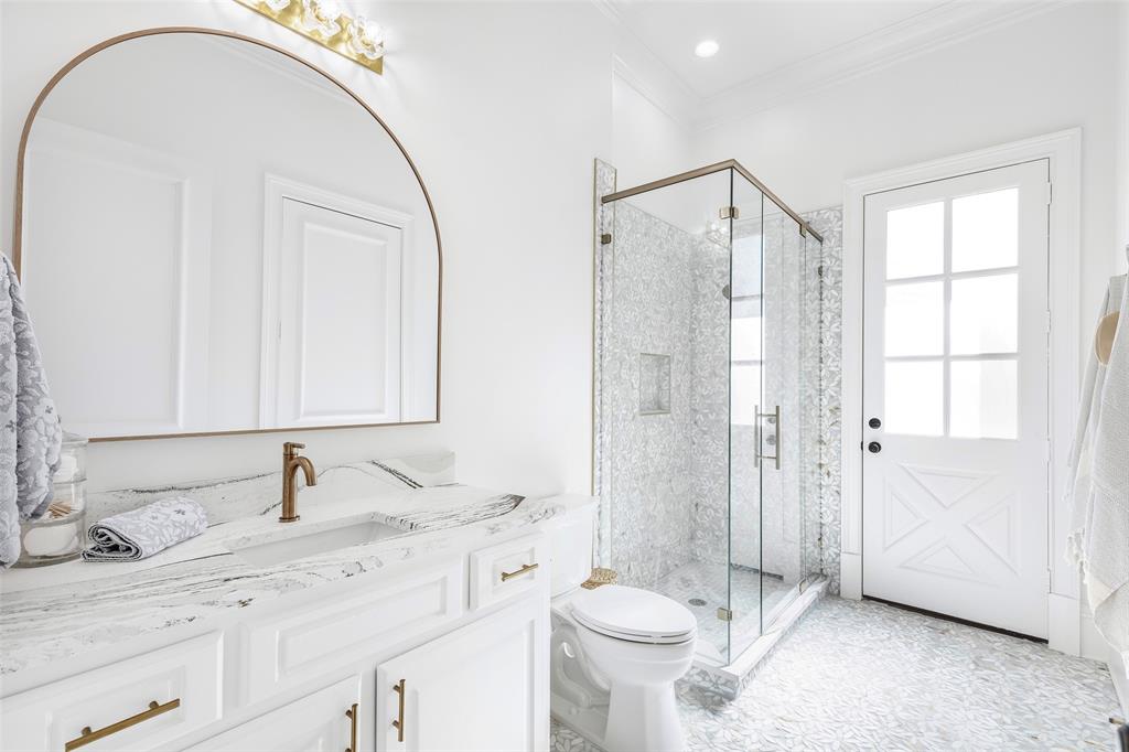 6401 St Michael Drive McKinney, TX 75072 - Photo 21 of 34 a bathroom with a double vanity sink toilet and shower