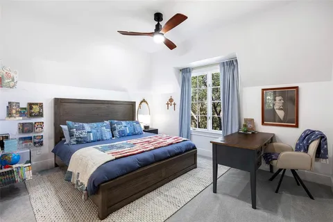 a bedroom with a bed a couch and a window