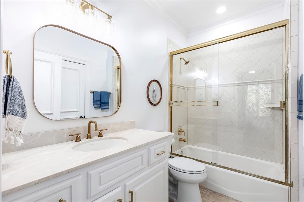 6401 St Michael Drive McKinney, TX 75072 - Photo 26 of 34 a bathroom with a double vanity sink toilet mirror and shower