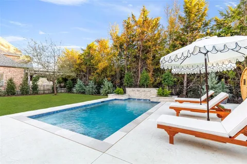 a view of a swimming pool with sitting area and furniture