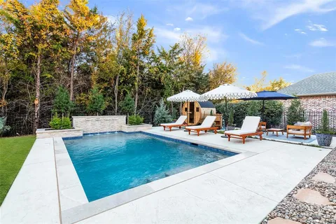 a view of a house with swimming pool and sitting area