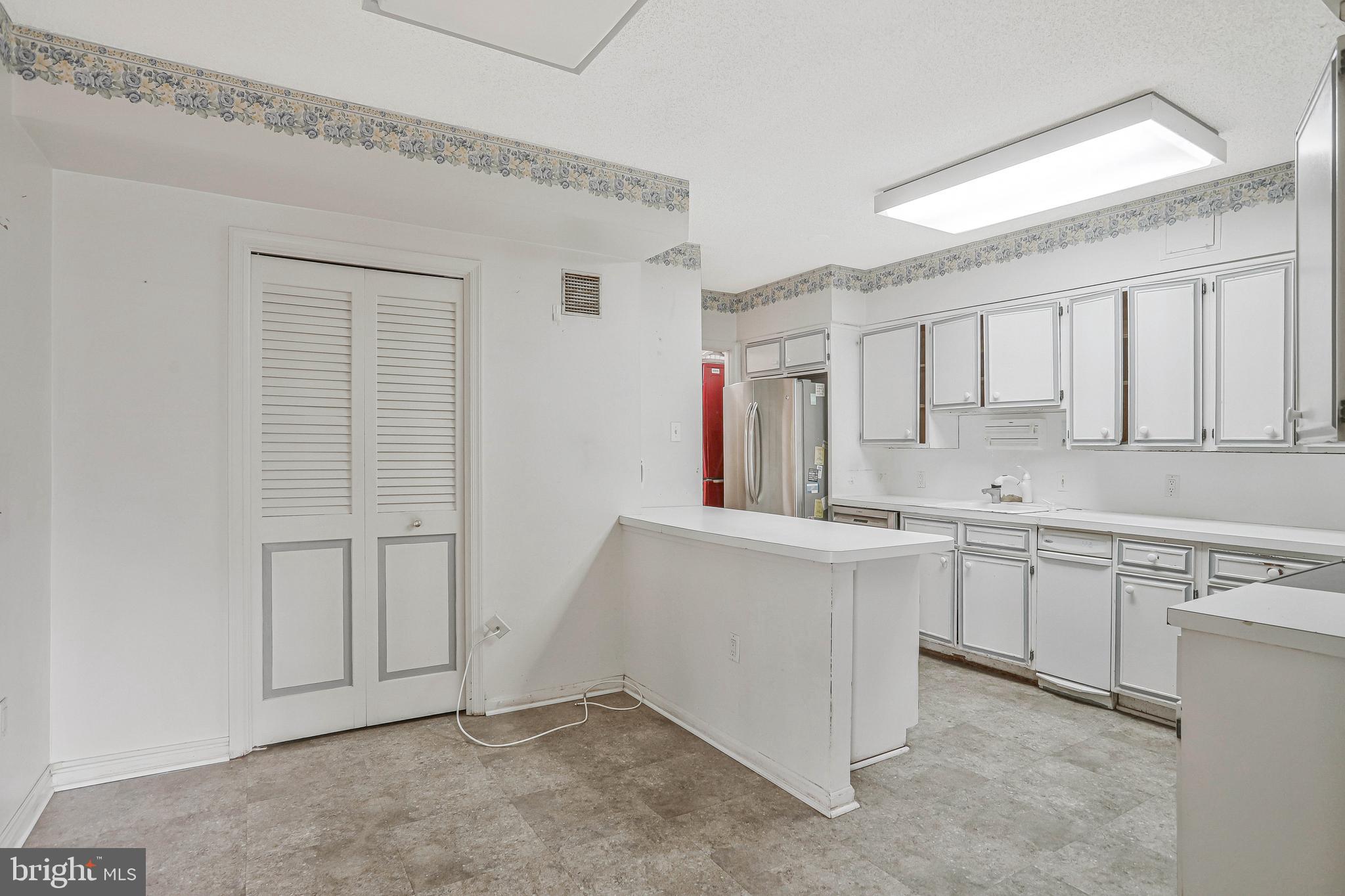 800 25th Street Northwest, Unit 502 Washington, DC 20037 - Photo 11 of 48 a large white kitchen with cabinets