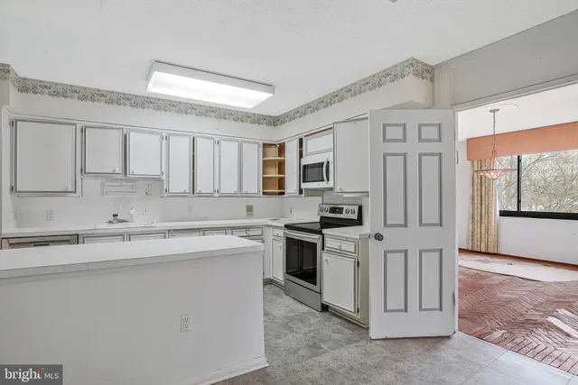 a kitchen with stainless steel appliances granite countertop a stove a sink dishwasher and a refrigerator