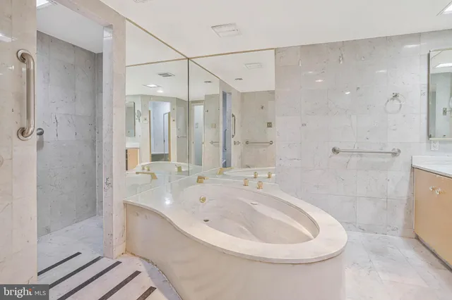 a large bathroom with a large tub shower and sink