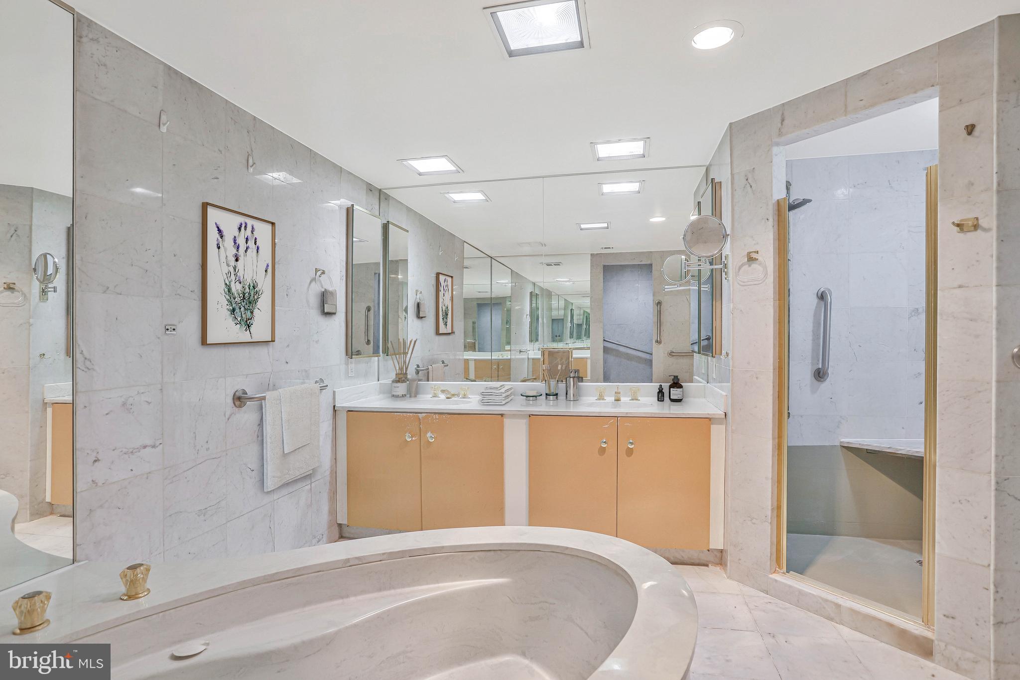 800 25th Street Northwest, Unit 502 Washington, DC 20037 - Photo 29 of 48 a large white bathroom with a tub shower sink and mirror