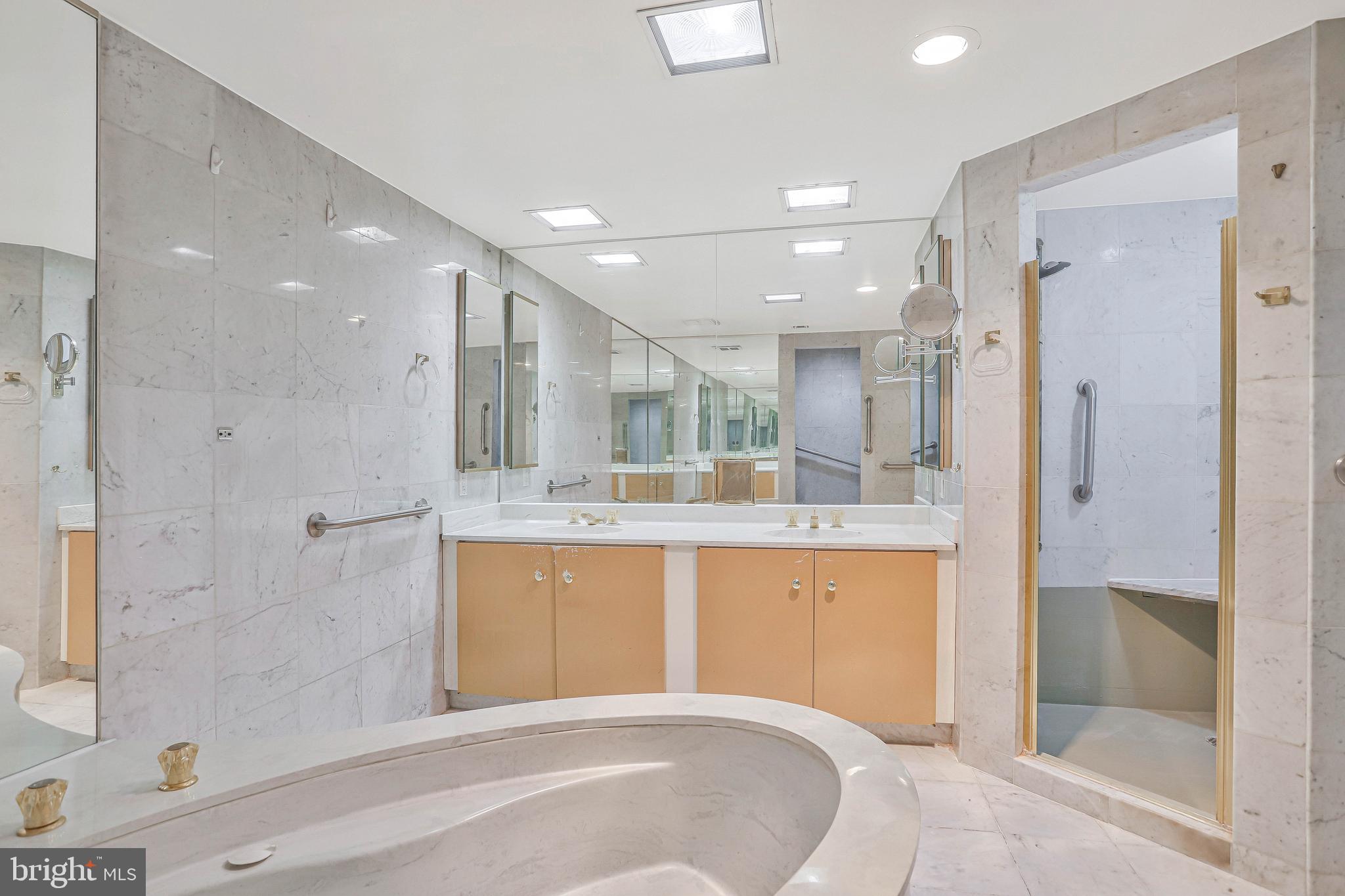 800 25th Street Northwest, Unit 502 Washington, DC 20037 - Photo 30 of 48 a large bathroom with a large tub shower and sink