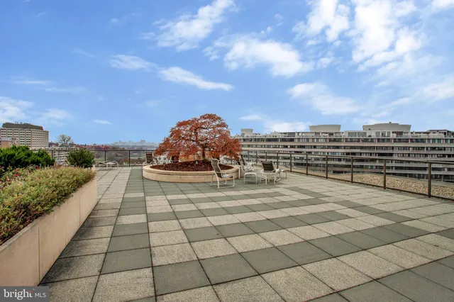 a view of a terrace with furniture and city view