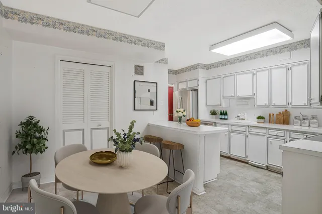 a kitchen with stainless steel appliances a sink and white cabinets