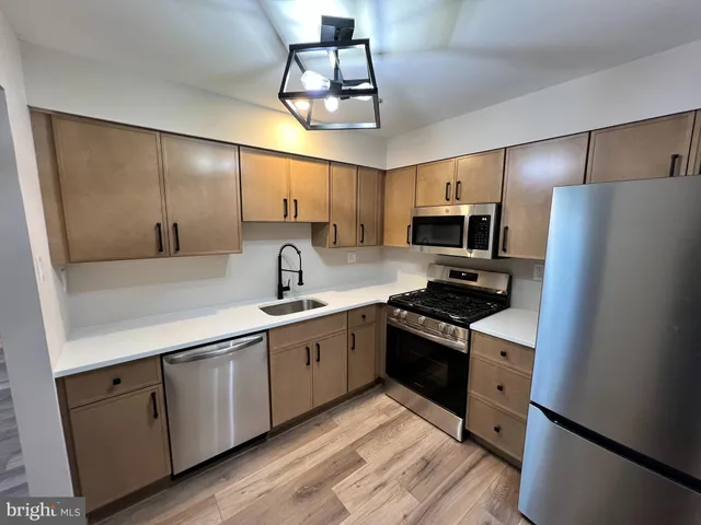 a kitchen with a sink stainless steel appliances and cabinets