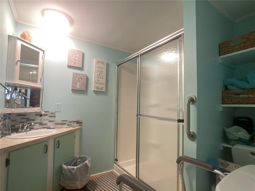 1710 7th Street Southwest, Unit 27 Ruskin, FL 33570 - Photo 18 of 26 a bathroom with a granite countertop sink toilet and shower