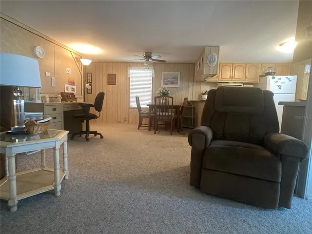 a living room with furniture and a piano