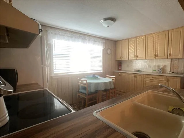 a kitchen with a sink cabinets and window