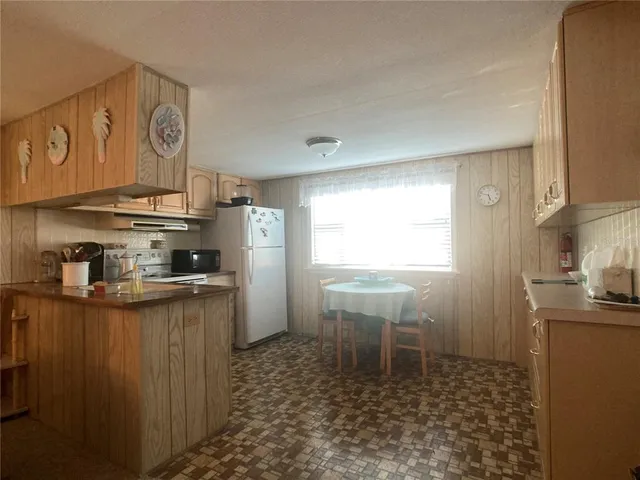 a kitchen with stainless steel appliances granite countertop a sink and cabinets